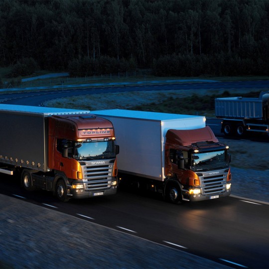 http://cargo.bold-themes.com/transport-company/wp-content/uploads/sites/2/2015/09/Three-orange-Scania-trucks-540x540.jpg